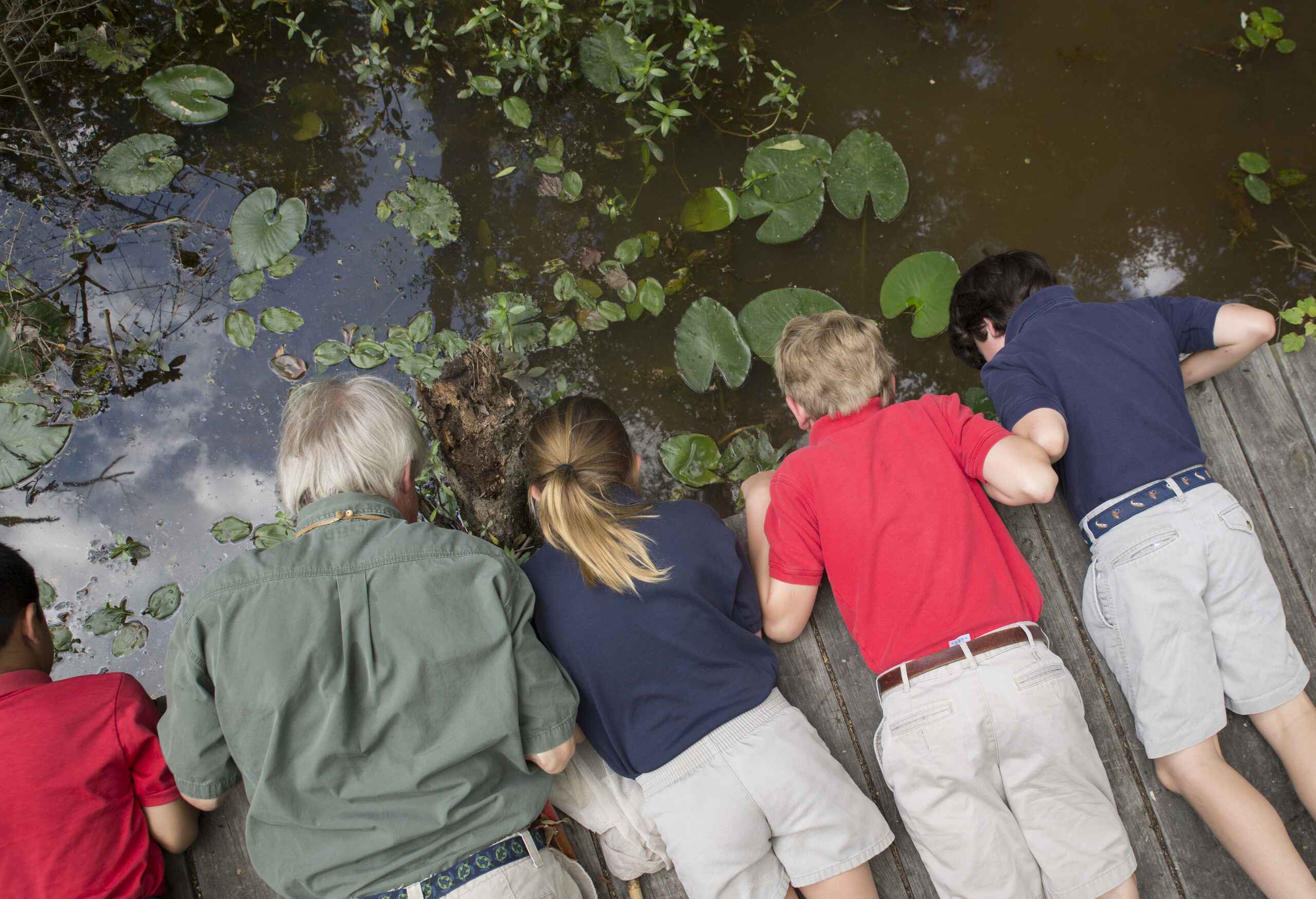 Kids looking over pond