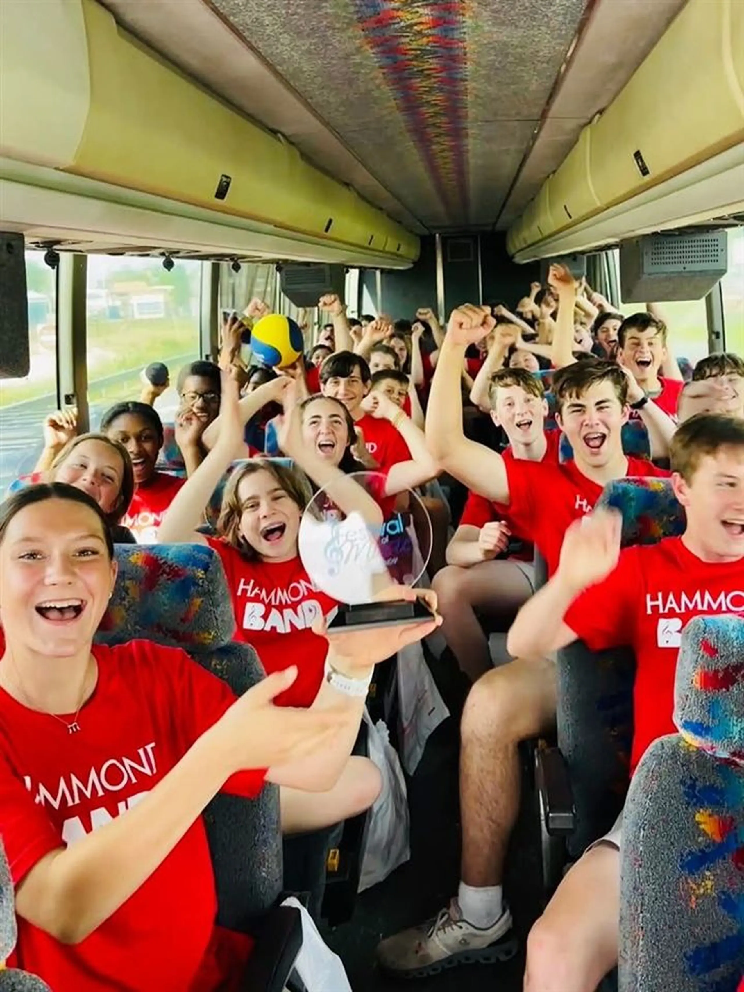 Students celebrating in the school bus